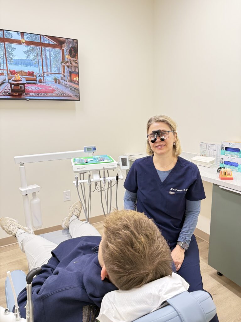 Dr. Mila Poznyak attending to a patient in her dental practice